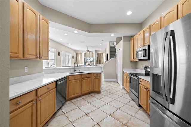 kitchen with ceiling fan, sink, stainless steel appliances, kitchen peninsula, and light tile patterned flooring