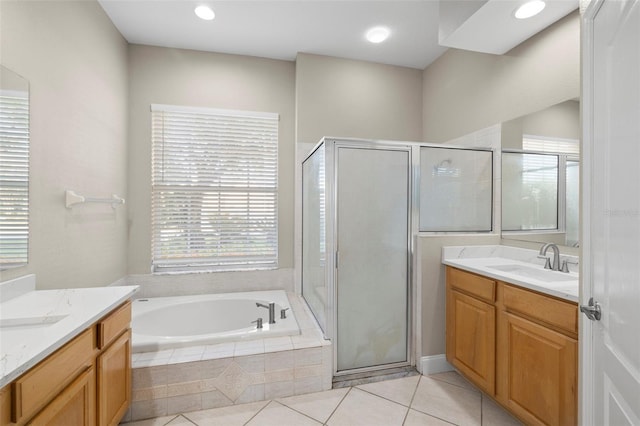 bathroom featuring tile patterned flooring, vanity, and separate shower and tub