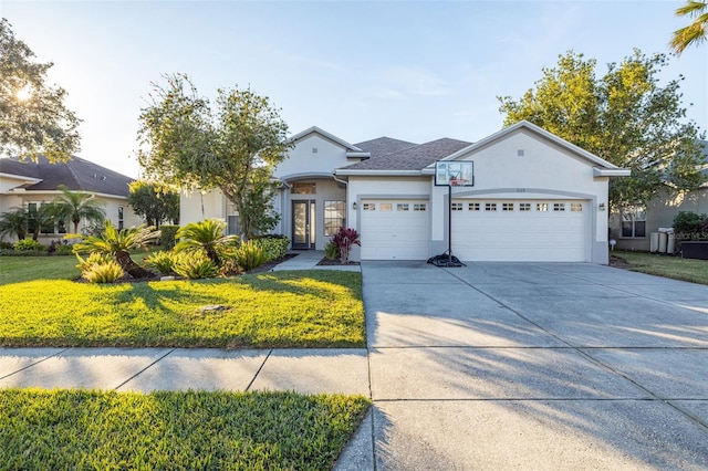 ranch-style house featuring a garage and a front lawn