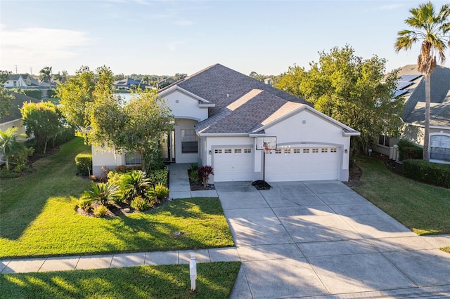 view of front of property featuring a garage and a front lawn