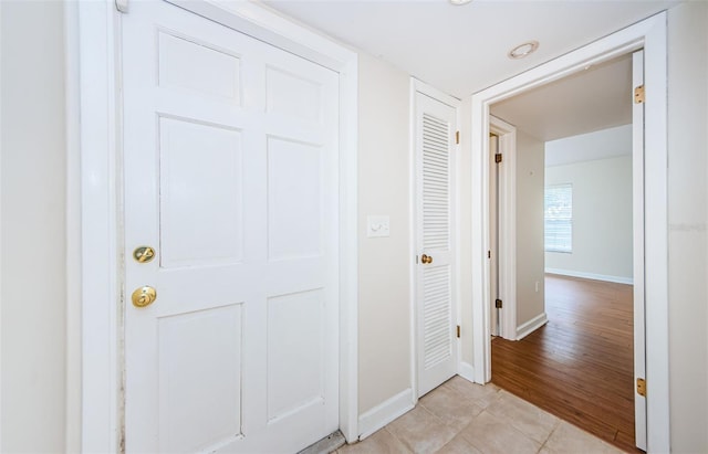 hall featuring light tile patterned flooring