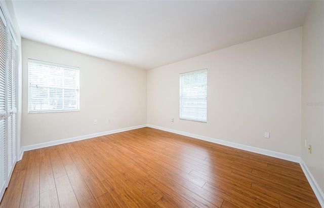 spare room featuring hardwood / wood-style flooring and a wealth of natural light