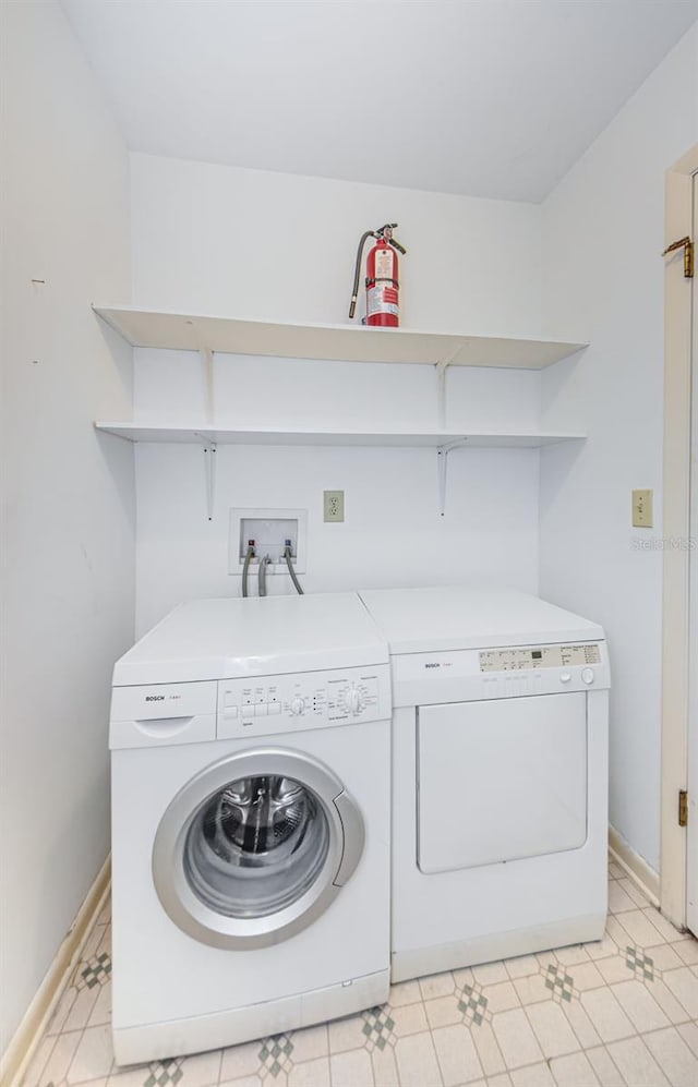 clothes washing area with separate washer and dryer