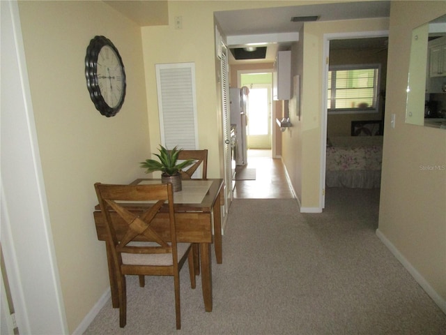 hall featuring carpet flooring