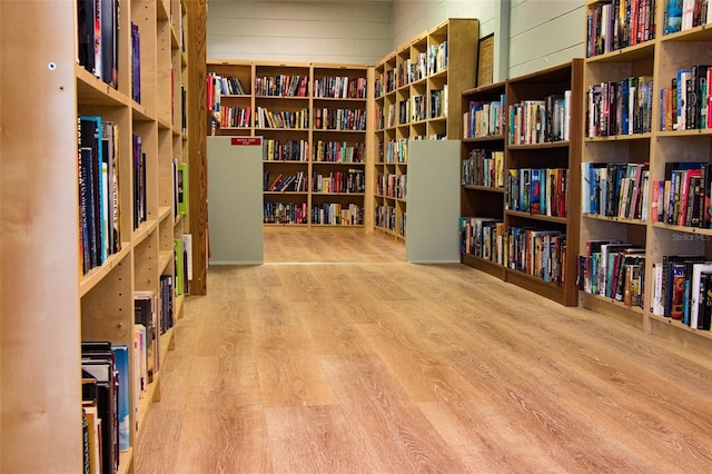 misc room featuring wood walls and light hardwood / wood-style flooring