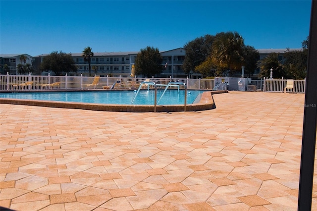 view of swimming pool with a patio area