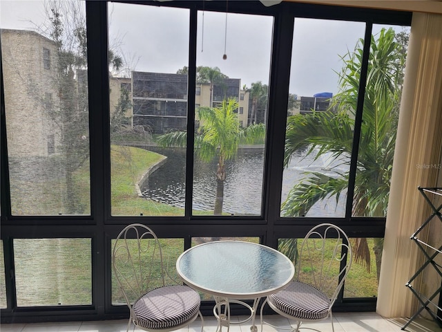 sunroom / solarium featuring a water view