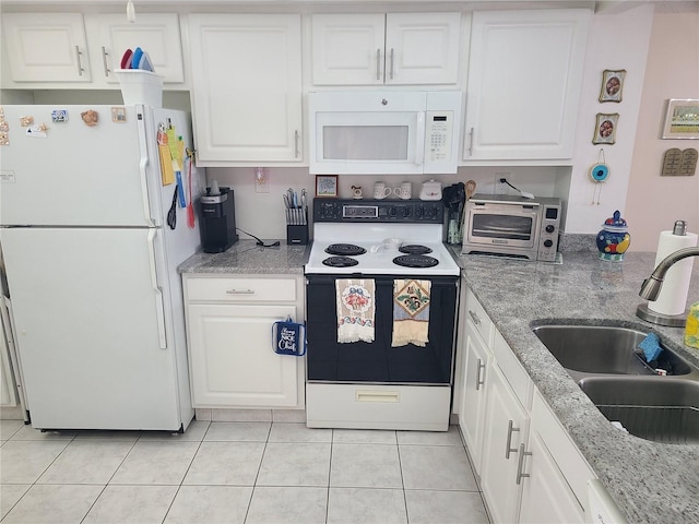 kitchen with white cabinets, light tile patterned floors, white appliances, and sink