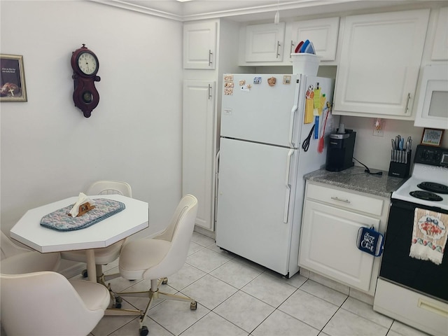 kitchen featuring white cabinetry, light tile patterned floors, and white appliances