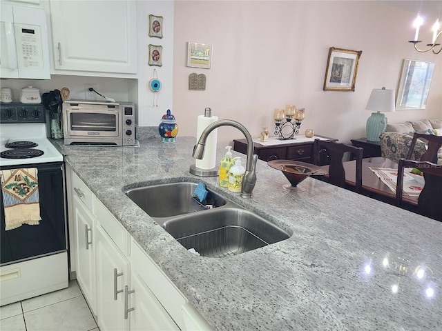 kitchen featuring light stone countertops, sink, light tile patterned flooring, white appliances, and white cabinets