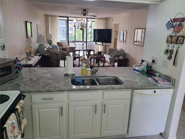 kitchen featuring white cabinetry, sink, white appliances, light tile patterned floors, and ceiling fan with notable chandelier