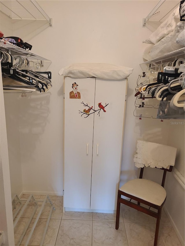 walk in closet featuring light tile patterned flooring