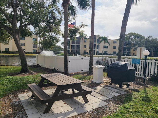 view of patio / terrace with a grill and a water view