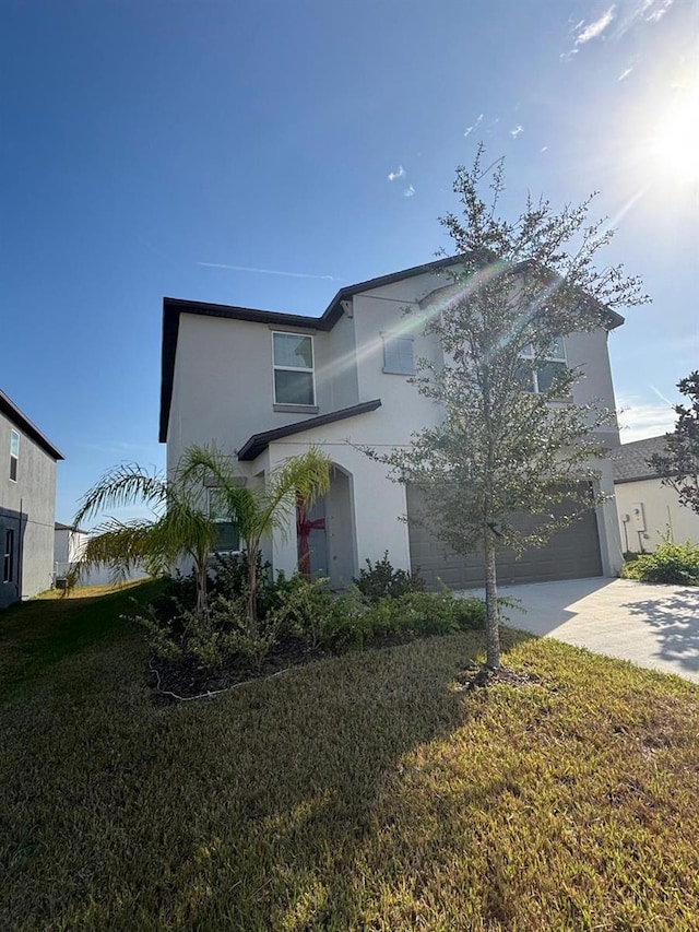 view of front of house with a front yard and a garage