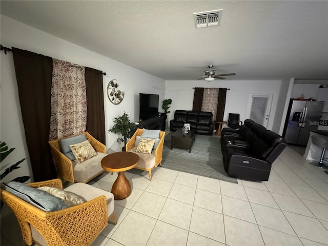 tiled living room with ceiling fan