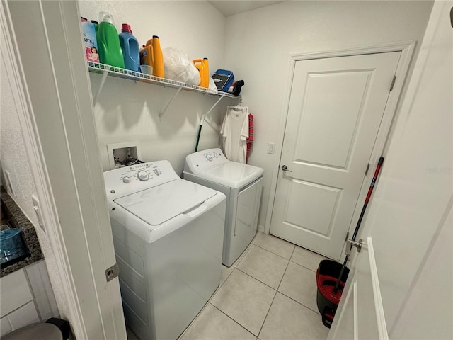 washroom featuring light tile patterned floors and separate washer and dryer