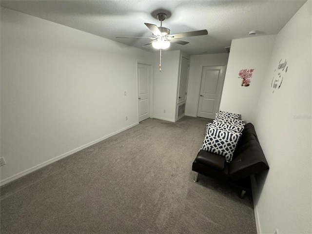 unfurnished room featuring ceiling fan, carpet, and a textured ceiling