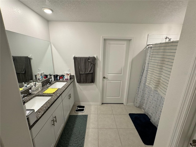 bathroom featuring curtained shower, a textured ceiling, vanity, and tile patterned flooring