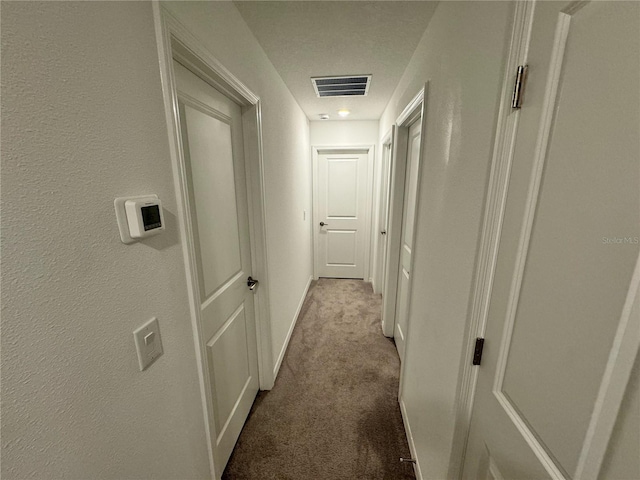 hallway with light colored carpet