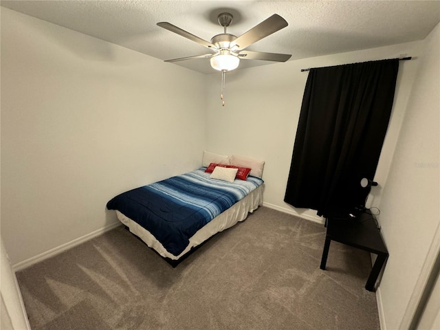 carpeted bedroom featuring ceiling fan and a textured ceiling