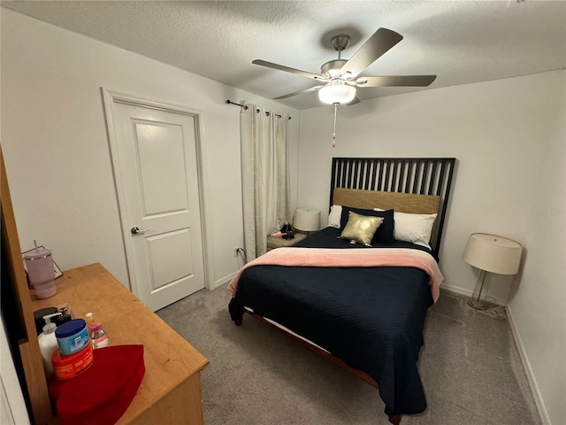 carpeted bedroom with ceiling fan and a textured ceiling