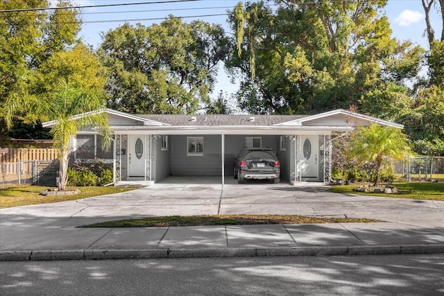 ranch-style home featuring a carport