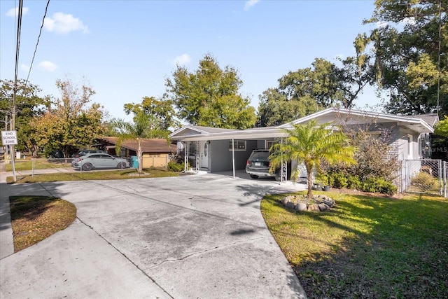 view of front facade with a carport and a front lawn