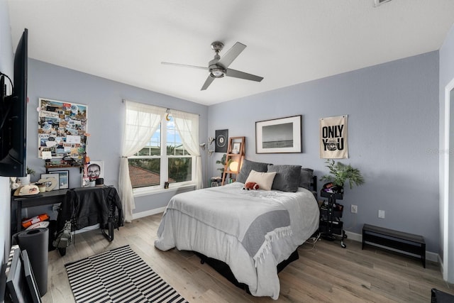 bedroom with ceiling fan and hardwood / wood-style flooring