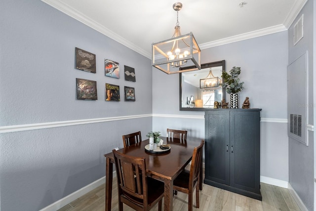 dining area featuring an inviting chandelier, ornamental molding, and light hardwood / wood-style flooring