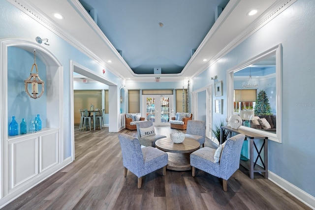 sitting room with a raised ceiling, french doors, crown molding, and hardwood / wood-style floors