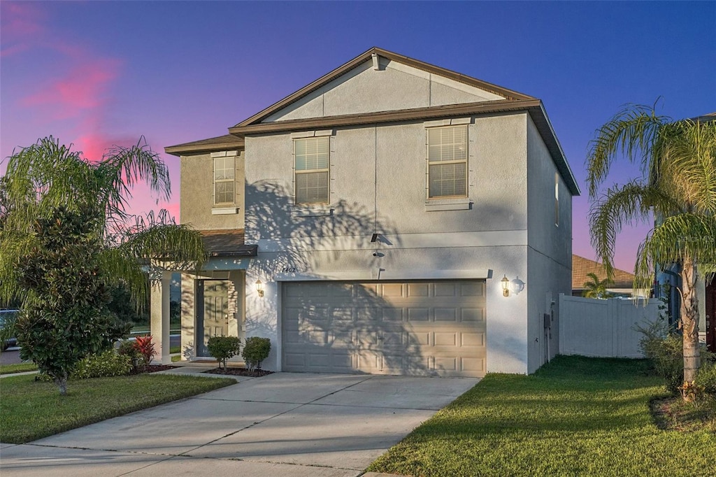 front of property featuring a lawn and a garage