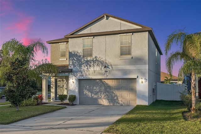 front of property featuring a lawn and a garage