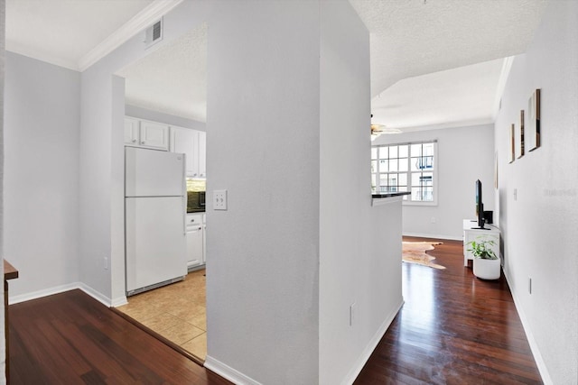 hallway featuring hardwood / wood-style flooring and ornamental molding