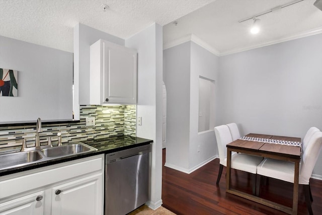 kitchen with dishwasher, sink, crown molding, decorative backsplash, and white cabinetry