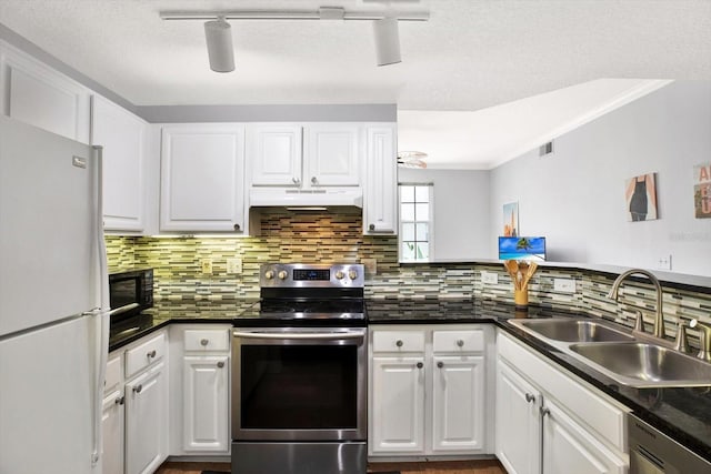 kitchen featuring sink, stainless steel appliances, crown molding, track lighting, and white cabinets