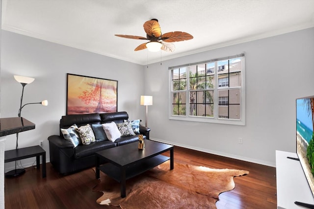 living room with ceiling fan, crown molding, and dark wood-type flooring