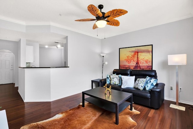 living room with ceiling fan, ornamental molding, and dark wood-type flooring