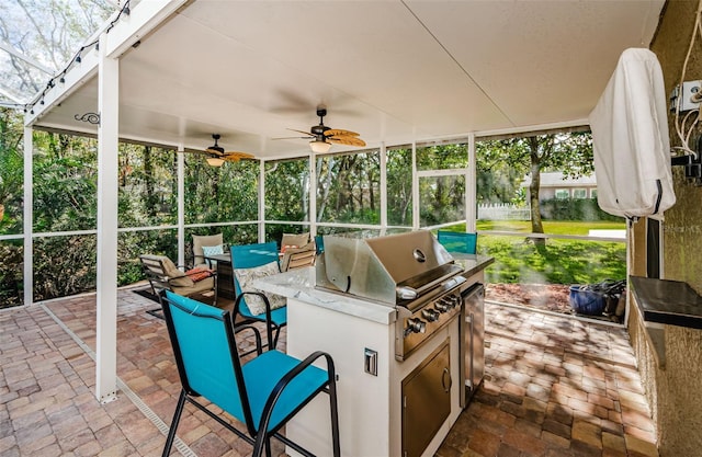 view of patio featuring area for grilling, grilling area, and ceiling fan