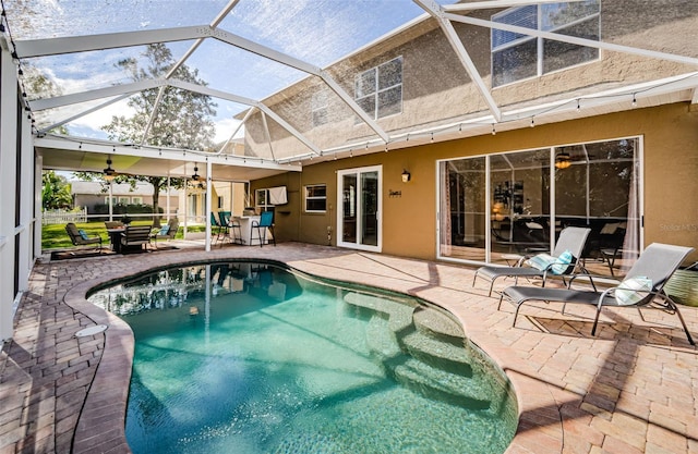 view of swimming pool featuring a lanai and a patio area