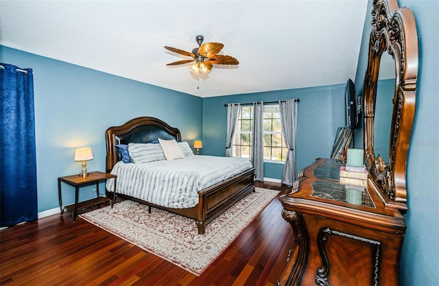 bedroom with dark hardwood / wood-style floors and ceiling fan