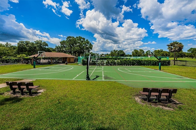 view of sport court featuring a yard