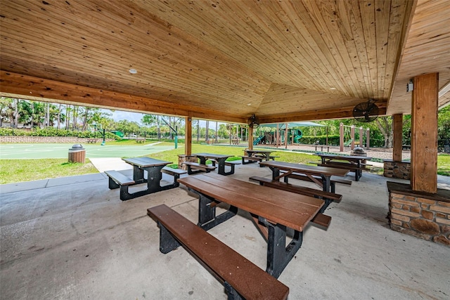 surrounding community featuring a playground, basketball court, and a lawn