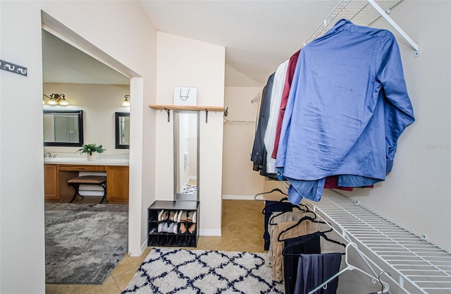 spacious closet with light tile patterned floors