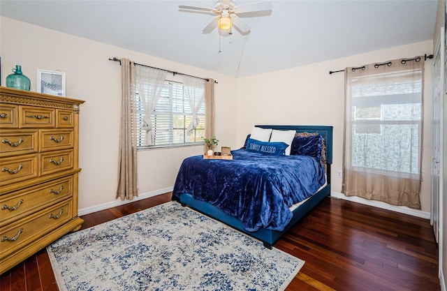 bedroom featuring dark hardwood / wood-style flooring, lofted ceiling, and ceiling fan