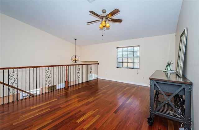 interior space featuring vaulted ceiling, ceiling fan, and dark hardwood / wood-style flooring