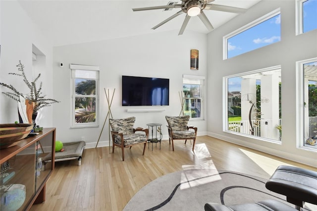 living room featuring ceiling fan and light wood-type flooring