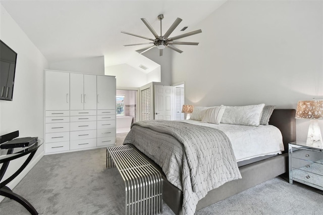 carpeted bedroom with connected bathroom, ceiling fan, a closet, and vaulted ceiling