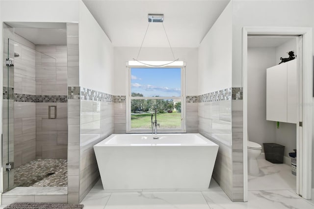 bathroom with plus walk in shower, toilet, and tile walls