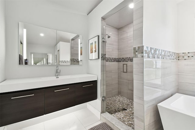 bathroom with tile patterned flooring, vanity, and plus walk in shower