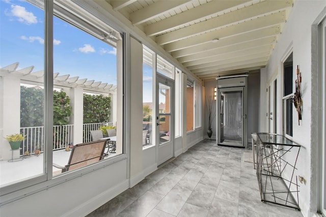 unfurnished sunroom with beamed ceiling and plenty of natural light